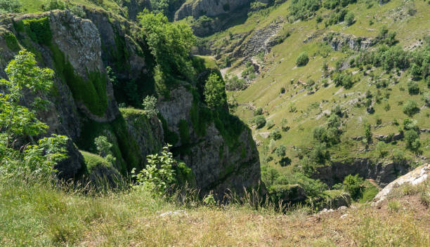 Looking down from the top of cheddar gorge Looking down from The cliff faces at the edge of Cheddar Gorge in Somerset cheddar gorge stock pictures, royalty-free photos & images