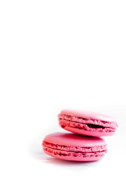 istock Two pink macaroons lie on a white background. 1330375445