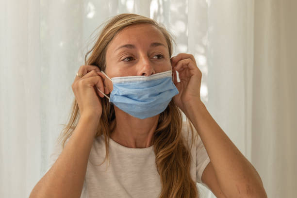 istock Frustrated  woman wearing protective face mask 1330378095