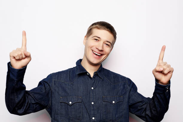 istock young man pointing a great idea, isolated over a white background 1330380381