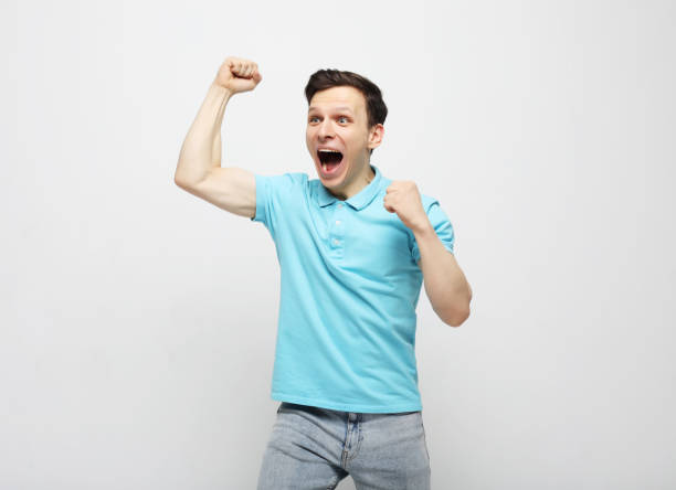 istock young man celebrating victory over white background 1330380546