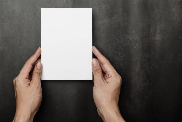 istock Hand holding Invitation card mockup, blank greeting card template. Flat lay, Minimalist style 1330381468