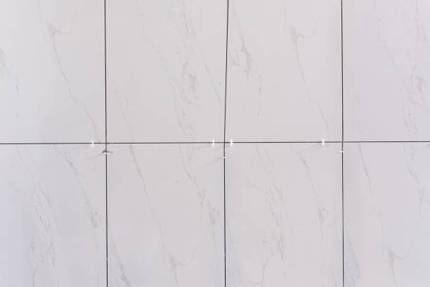 istock white plastic tile leveling use for install ceramic on cement floor in new room. square background full frame 1330381788