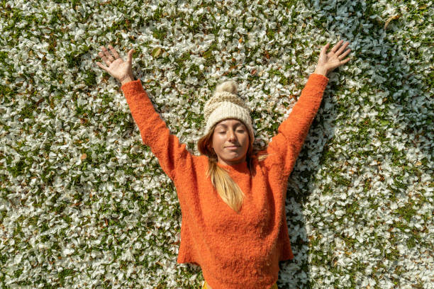 istock Young woman lying on a flower bed 1330386118