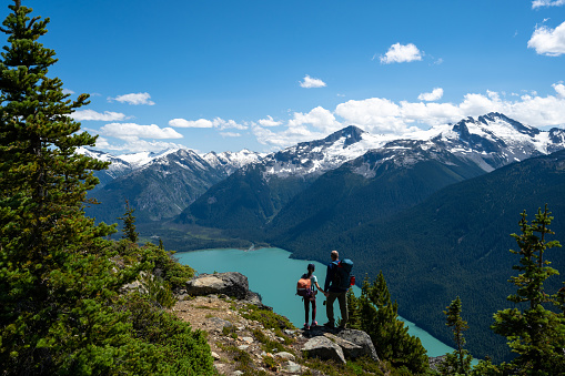 Hiking in Whistler, BC, Canada. Summer vacations in the mountains. Father and daughter bonding in nature.