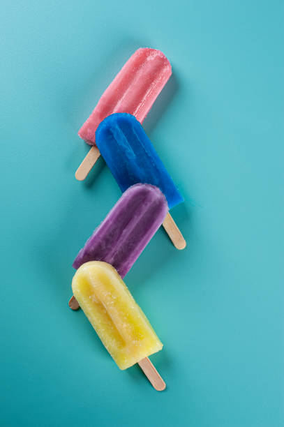 istock Several popsicles of assorted flavors together on a blue background 1330390217