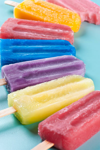 istock Several popsicles of assorted flavors together on a blue background 1330390235
