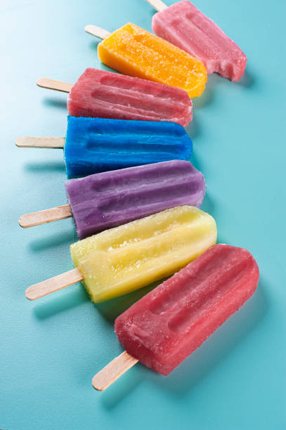 istock Several popsicles of assorted flavors together on a blue background 1330390242