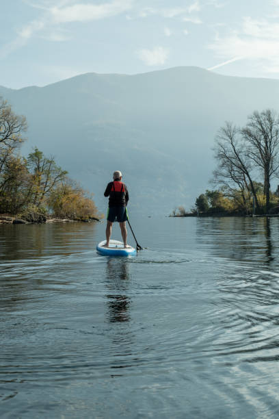istock Man paddling on a stand up paddle board 1330390473