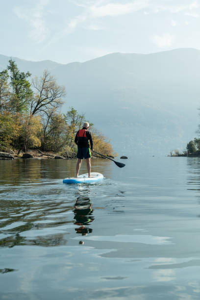 istock Man paddling on a stand up paddle board 1330390488