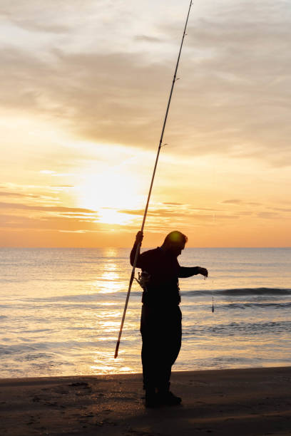 istock fisherman fishing at sunrise 1330392023