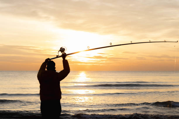 istock fisherman fishing at sunrise 1330392025