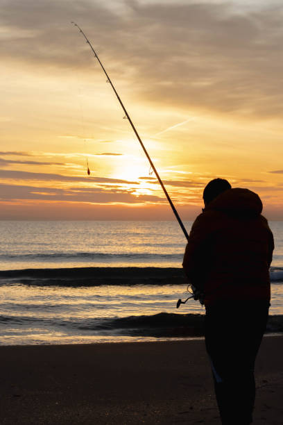 istock fisherman fishing at sunrise 1330392030