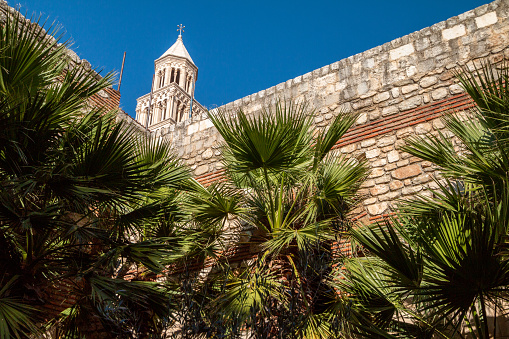 Part of the ancient walls of Diocletian's Palace in Split, Croatia with St Domnius Cathedral is peeking over the walls.