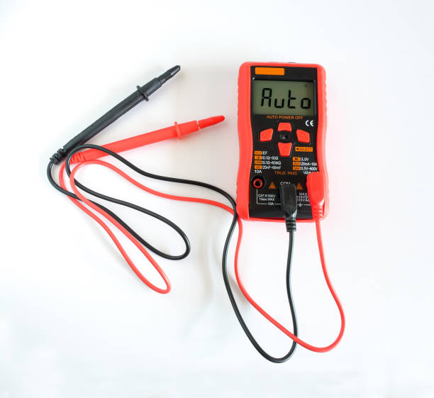 istock Digital multimeter in red case with probes and backlit display. 1330395084