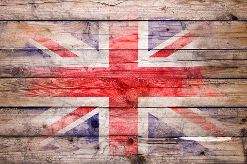 Flag of United Kingdom watercolor painted on a old wooden boards. Grunge flags texture. Background concept. Full color. Horizontal orientation. Faded effect.