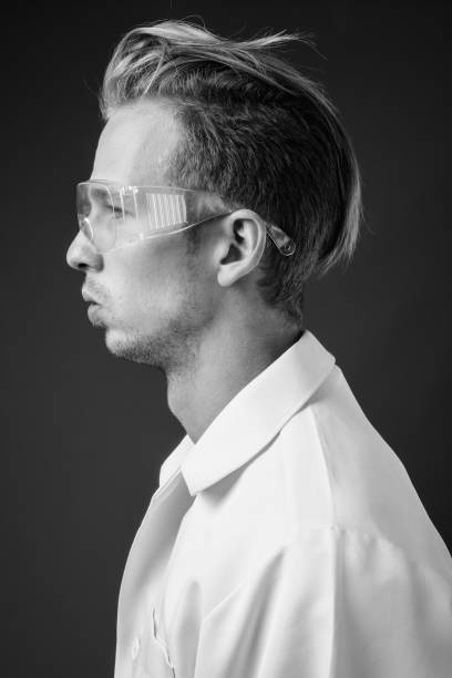istock Young handsome man doctor as scientist with protective glasses 1330396741