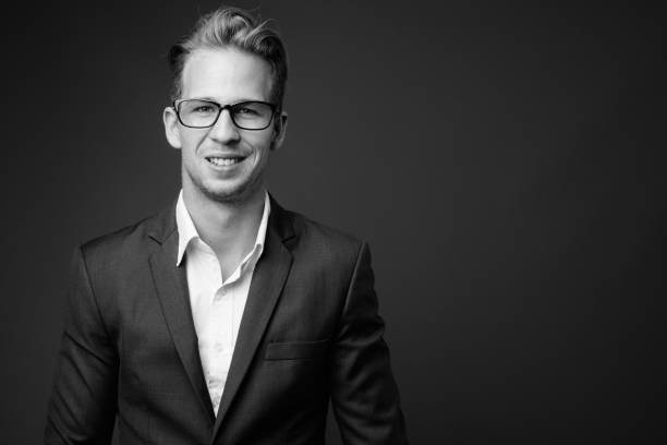 istock Young handsome businessman wearing suit in black and white 1330396939