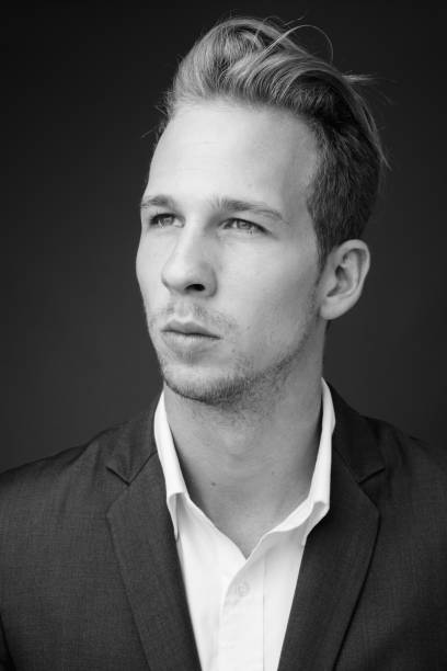 istock Young handsome businessman wearing suit in black and white 1330396959