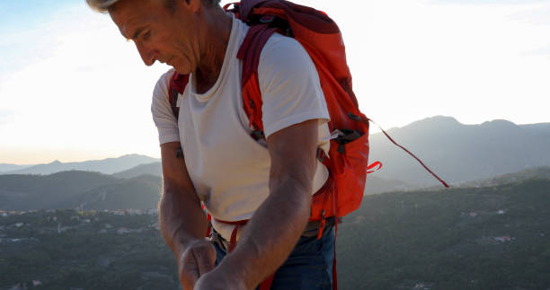 istock Mountaineer rappels off mountain ridge at sunrise 1330399208