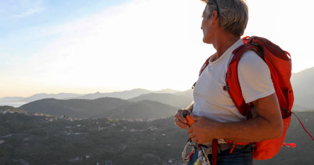 istock Mountaineer relaxes on mountain ridge at sunrise 1330399211