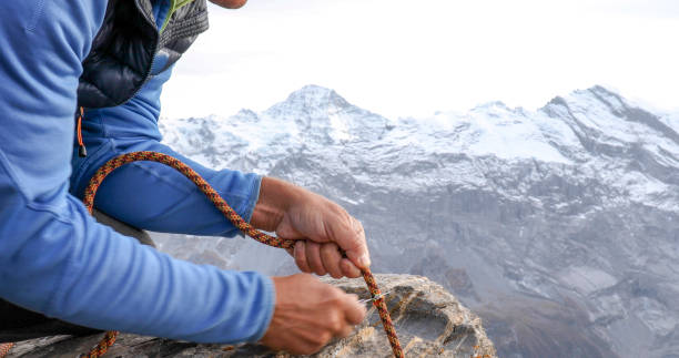 istock View of man cutting climbing rope on mountain ridge 1330400129
