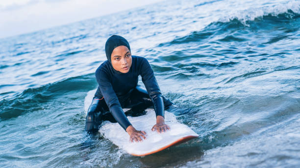 istock Female surfer with hijab in sea 1330401264