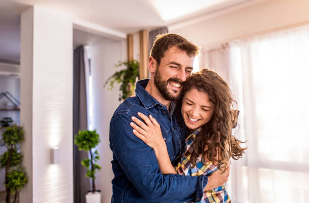 istock Young couple embracing at home. 1330402268