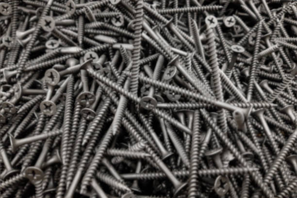 istock Self-Tapping Screw Silver Steel Lot Pile Construction Shop Background Blurred 1330402427