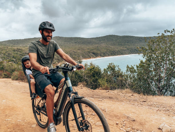 istock father on the ebike with the son 1330403440