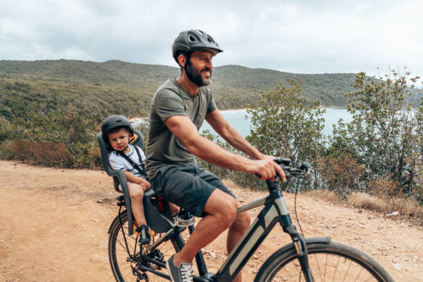 istock father on the ebike with the son 1330403461
