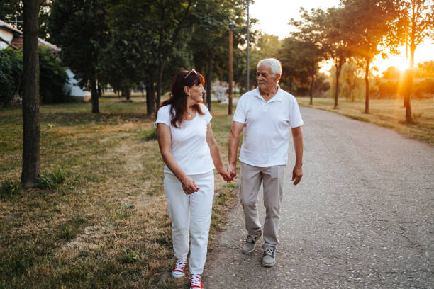 istock Cheerful senior couple taking a walk at sunset 1330408767