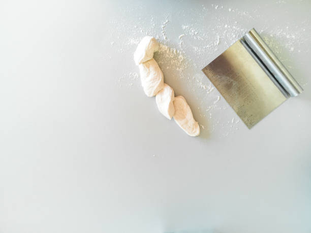 istock Spatula and sliced dough on the table 1330410200