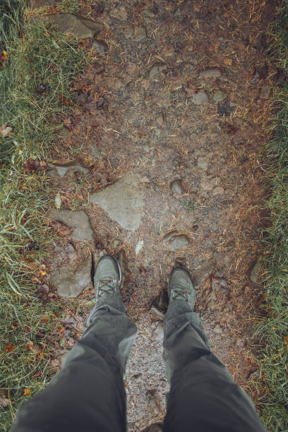 istock A hiker's POV looking down on a muddy trail. 1330410320