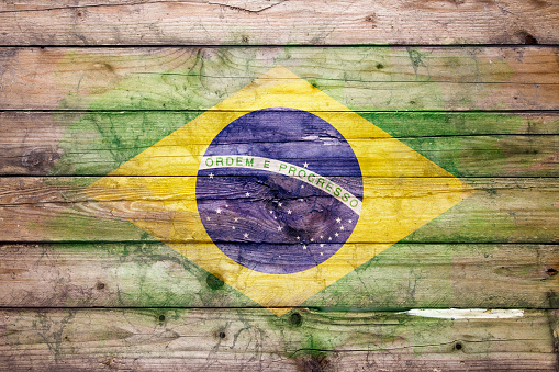 Flag of Brazil watercolor painted on a old wooden boards. Grunge flags texture. Background concept. Full color. Horizontal orientation. Faded effect.