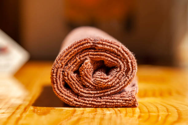 istock Brown three-ply microfibre tea towel rolled up on a wooden surface 1330412807