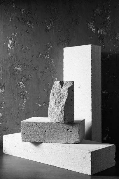 istock Aerated concrete block cube or bricks near plaster wall background texture. Construction concept minimalism design 1330412991