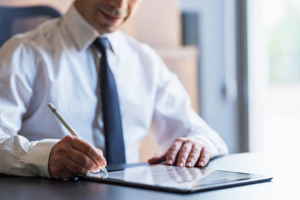 istock Man Signing The Digital Contract 1330418047