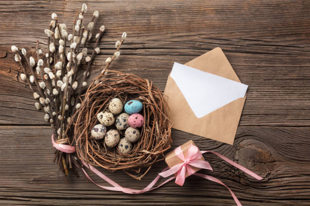 istock Quails eggs in nest, gift box and flowers. Easter greeting card. Top view 1330420946