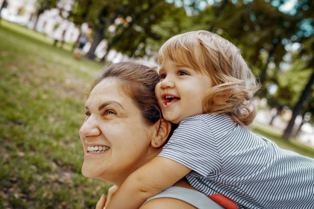 istock Mother with daughters in park in summer afternoon 1330421119