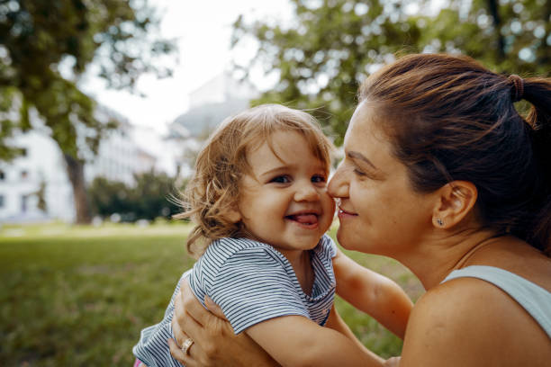 istock Mother with daughters in park in summer afternoon 1330421126