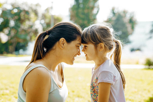 istock Mother with daughters in park in summer afternoon 1330421962