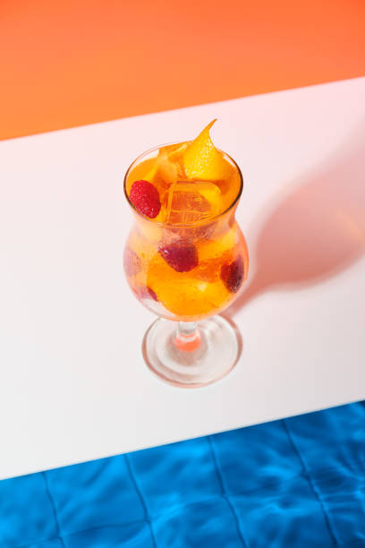 istock Bright cool orange cocktail with raspberries and ice cubes by the pool. Toning refreshing drink. Soft drinks on a hot summer day. Beach party in summer 1330424199