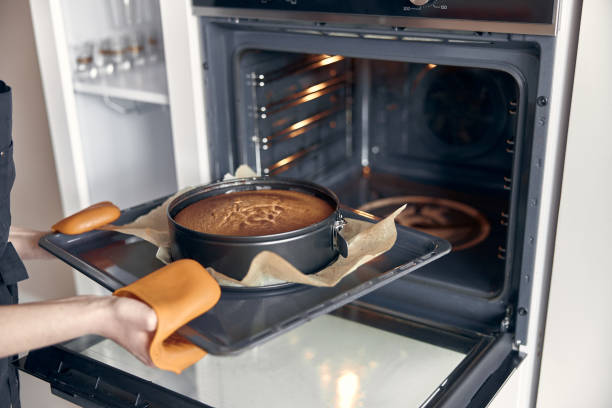 istock young professional female cook is preparing tasty cake at her light modern kitchen 1330425975