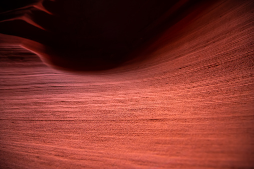 Abstract closeup of pink dark orange red shadows and light at upper Antelope slot canyon with wave shape rock sandstone in Page, Arizona