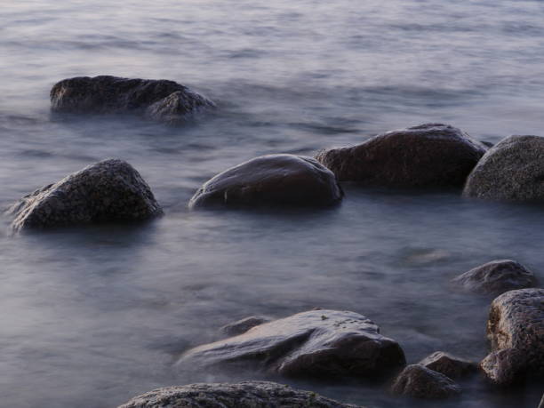 istock stones in sea water long exposure 1330426441