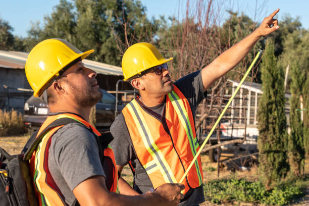 trabajadores hispanos con un casco de trabajo mirando hacia otro lado - trabajador emigrante fotografías e imágenes de stock