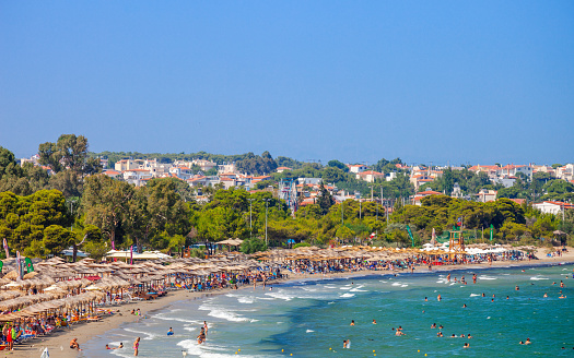 Aerial view of enjoying at beach woman and  clear turquoise water of mediterranean sea.