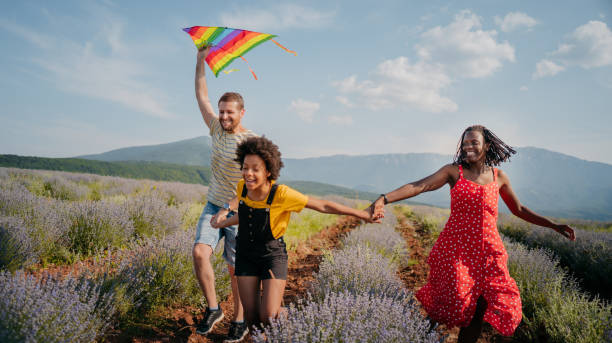 istock Happy couple running a kite 1330437512