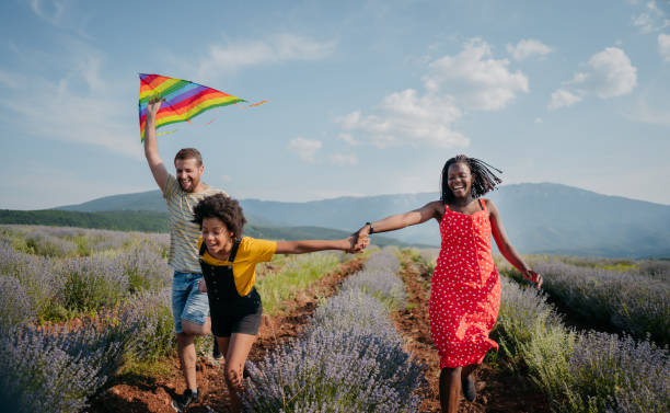 istock Happy couple running a kite 1330437563